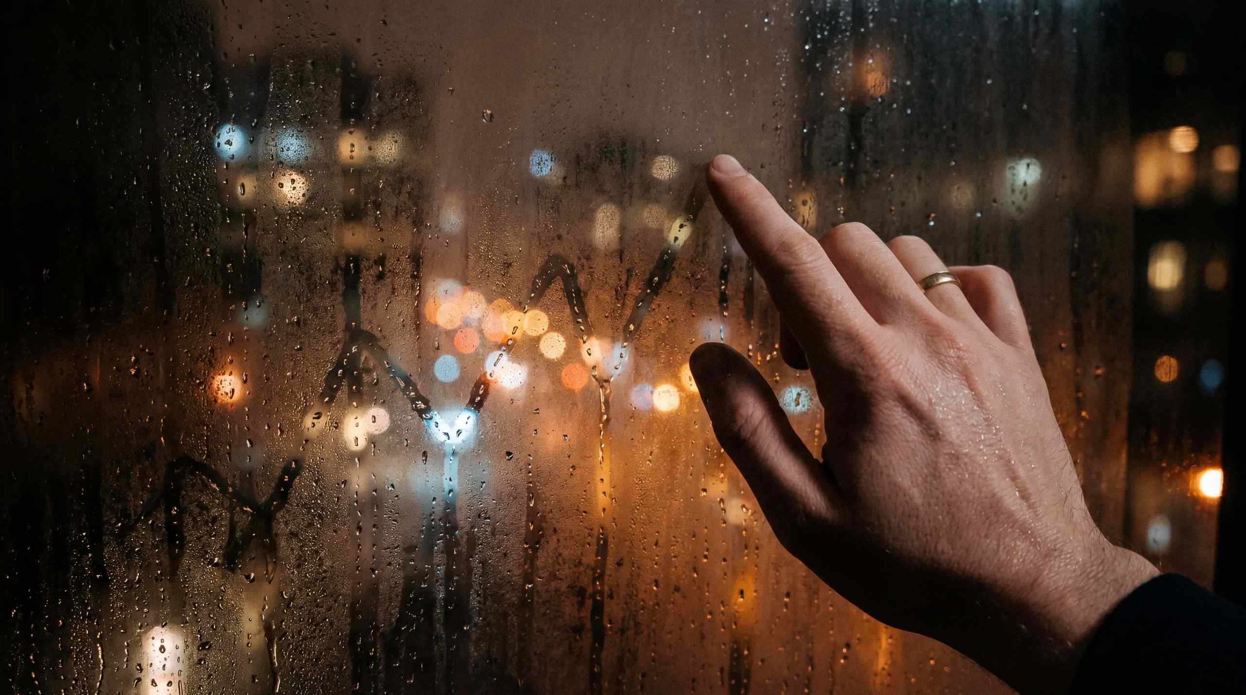 Charting something on a window with condensation.